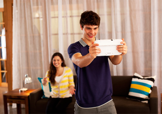 Illustration for article titled It's Time for Pictures of People Looking Like Idiots Playing the Wii U